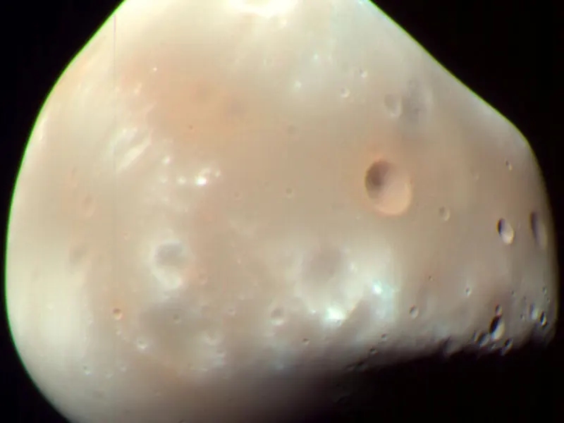 A small, smooth, lumpy grey moon