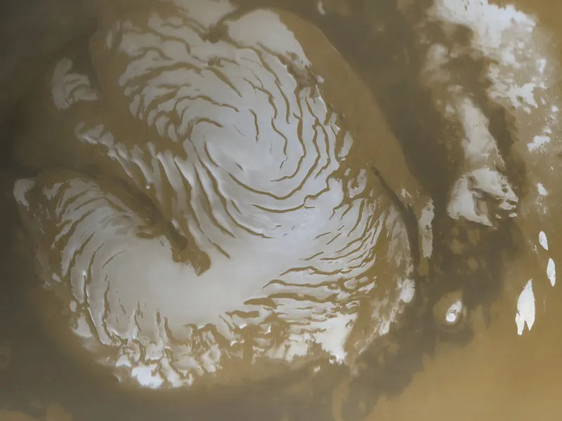 The white north polar ice cap of Mars, surrounded by reddish ground